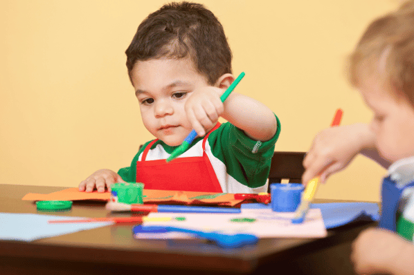 Toddler painting in art class