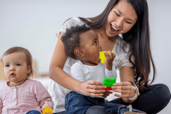 Teacher with toddler at daycare.