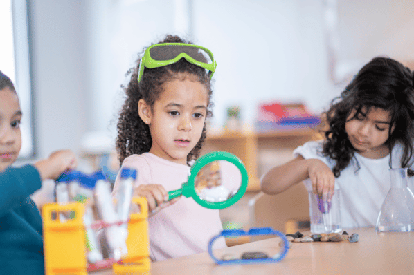 Children at daycare exploring science lesson.