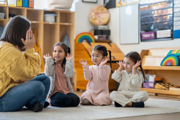 Teacher with three children in music class.