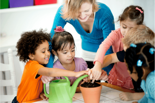 Image shows children in a preschool classroom building a community by planting together.