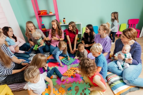 Families with children of different ages gathered at a childcare center.