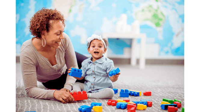 daycare staff engaging with an infant based on a lesson plan