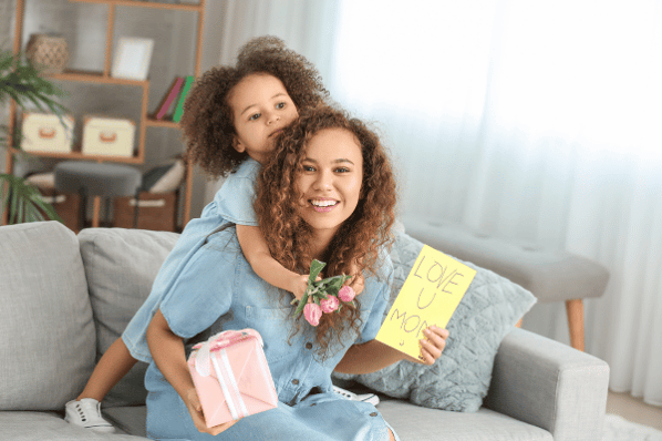 Woman with gift for Mother's Day from her child.