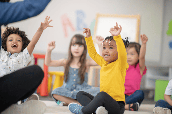 three young children singing songs at preschool