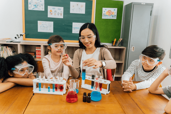 Teacher and students doing a science experiment in class.