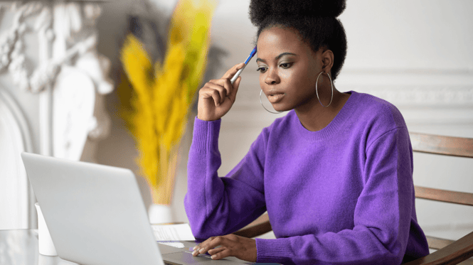 an image of woman studying on her laptop